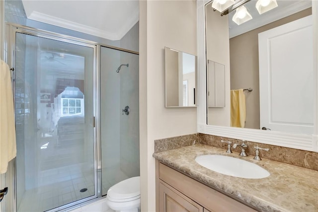 bathroom with a stall shower, vanity, toilet, and crown molding