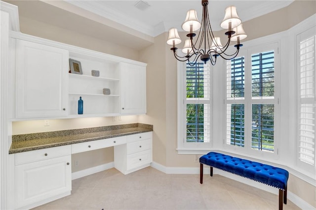 home office with light tile patterned floors, a chandelier, baseboards, ornamental molding, and built in desk