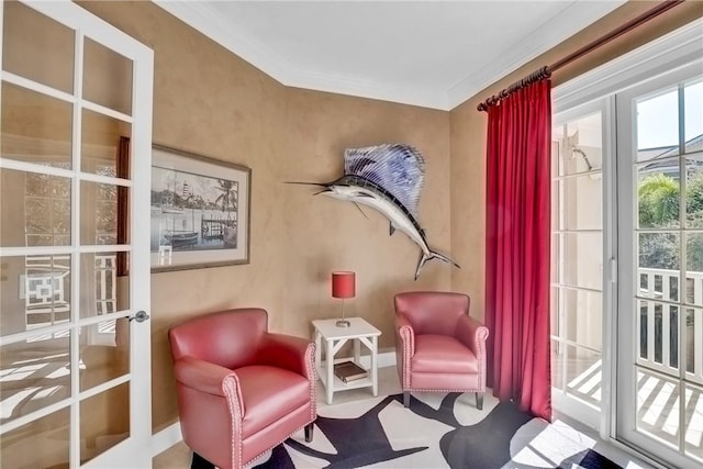 sitting room with ornamental molding, french doors, and baseboards