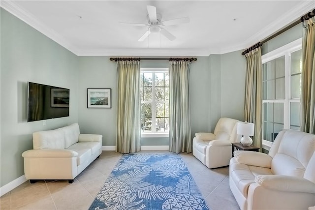 living area featuring light tile patterned floors, baseboards, and crown molding