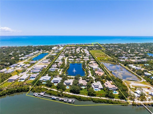 birds eye view of property with a water view and a residential view