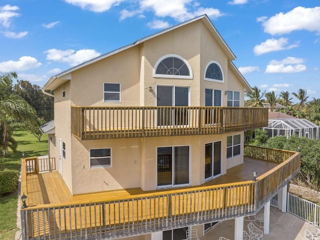 8820 44th Ave, Sebastian, FL 32958 - rear view of house featuring stucco siding and a balcony