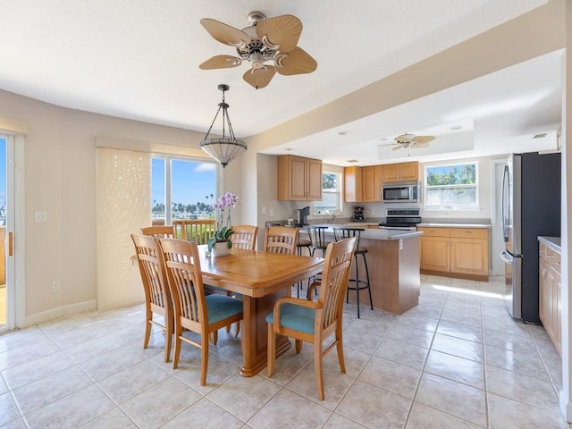 8820 44th Ave, Sebastian, FL 32958 - dining space featuring ceiling fan, light tile patterned flooring, and a raised ceiling