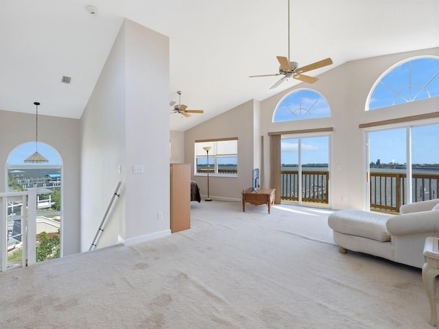8820 44th Ave, Sebastian, FL 32958 - living room with high vaulted ceiling, carpet flooring, healthy amount of natural light, and ceiling fan