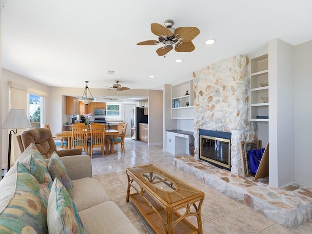 8820 44th Ave, Sebastian, FL 32958 - living area with ceiling fan, a fireplace, built in features, light tile patterned floors, and recessed lighting