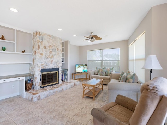 8820 44th Ave, Sebastian, FL 32958 - tiled living area featuring a stone fireplace, ceiling fan, recessed lighting, and built in features