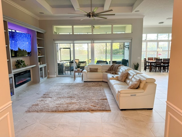 living room with ceiling fan, a healthy amount of sunlight, built in shelves, and ornamental molding