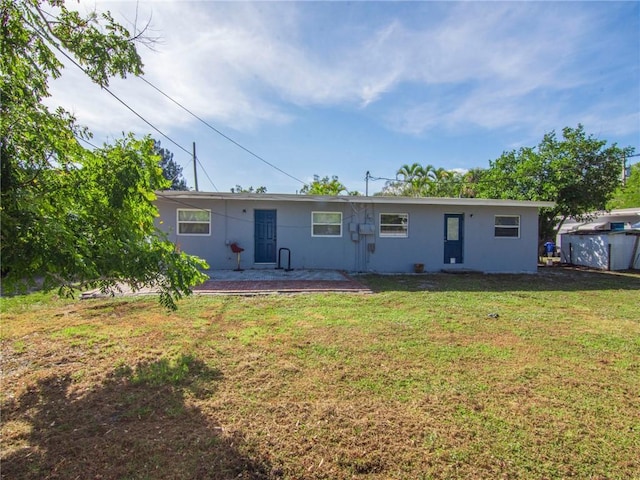 2156 18th St, Vero Beach, FL 32960 - rear view of property with a lawn, a patio, and stucco siding