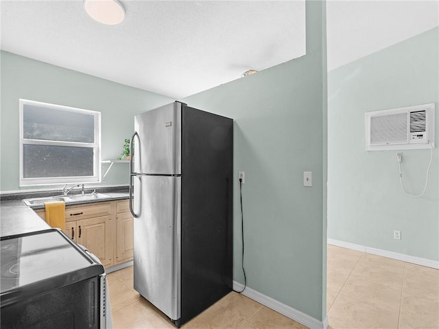 2156 18th St, Vero Beach, FL 32960 - kitchen with freestanding refrigerator, range, an AC wall unit, dark countertops, and light brown cabinets