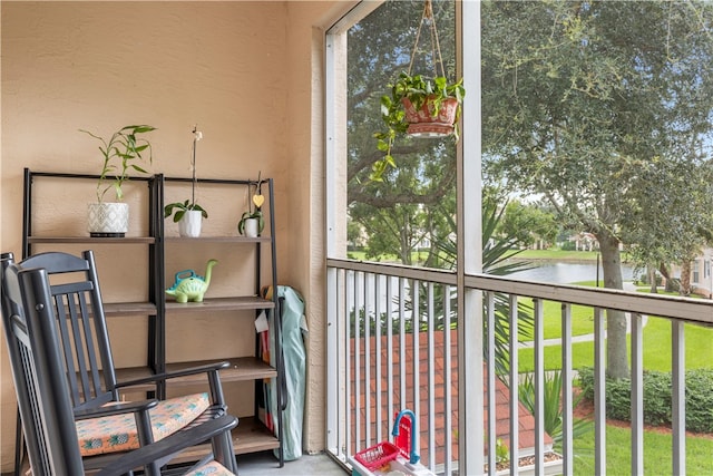 sunroom / solarium with a water view