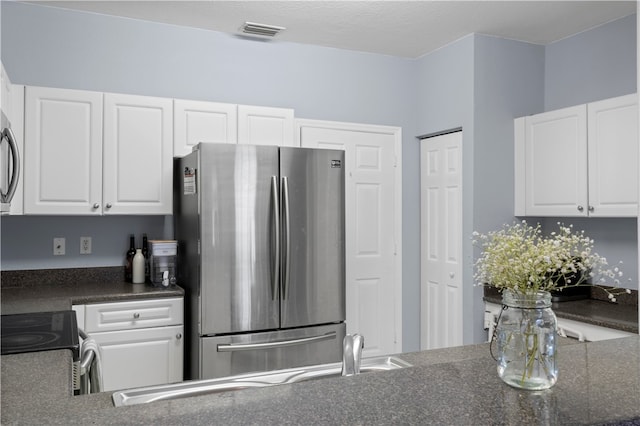 kitchen featuring white cabinets and appliances with stainless steel finishes