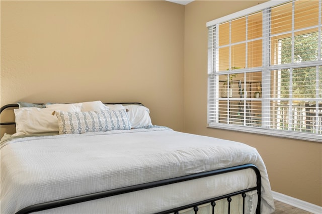 bedroom with hardwood / wood-style floors