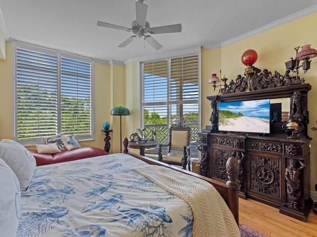 bedroom with crown molding, ceiling fan, and wood finished floors