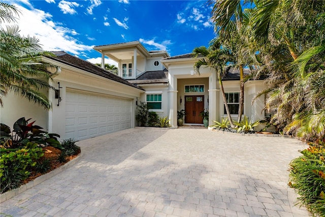 view of front of home featuring a garage and a balcony