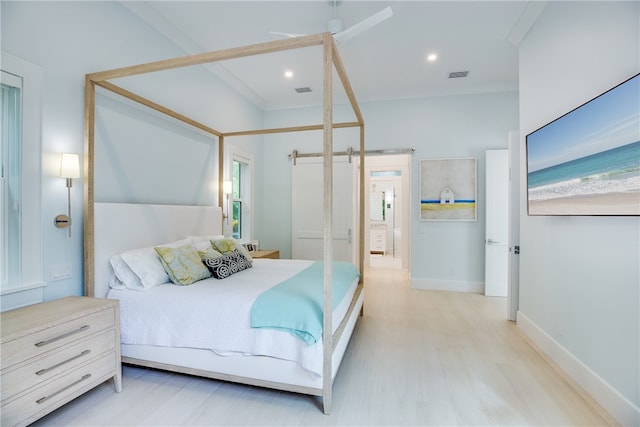 bedroom with light hardwood / wood-style floors, multiple windows, and ornamental molding