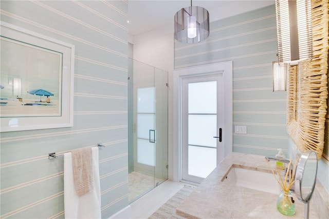 bathroom with vanity and a shower with door