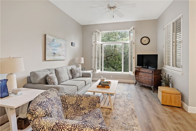 living room with light hardwood / wood-style floors and ceiling fan