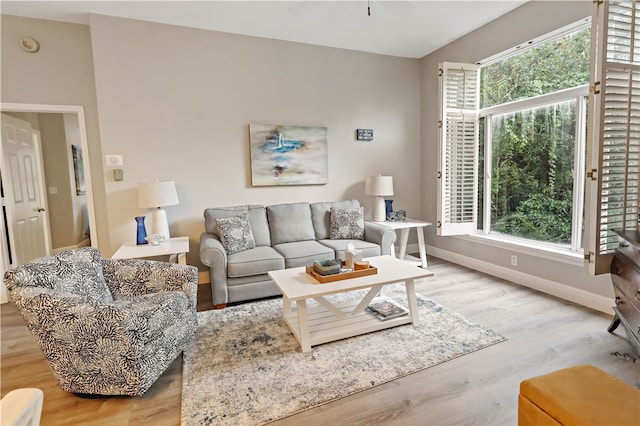 living room with light hardwood / wood-style floors and ceiling fan