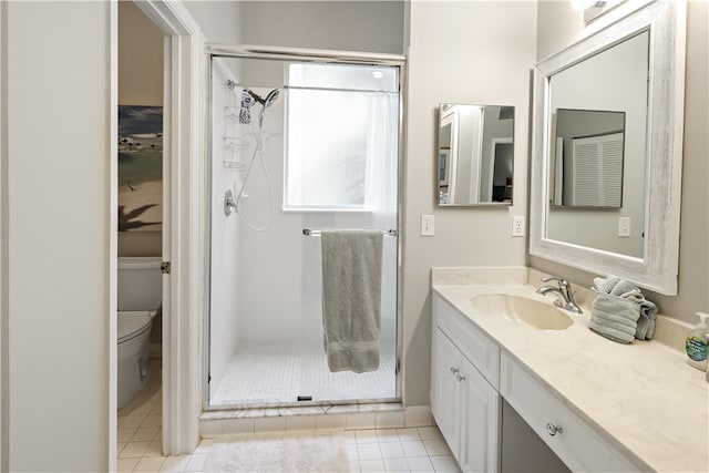 bathroom featuring toilet, vanity, an enclosed shower, and tile patterned flooring