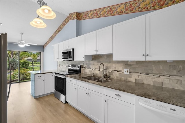 723 Timber Ridge Trl SW Unit B, Vero Beach, FL 32962 - kitchen with stainless steel appliances, lofted ceiling, white cabinetry, and backsplash