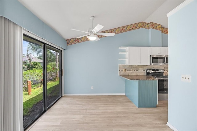 723 Timber Ridge Trl SW Unit B, Vero Beach, FL 32962 - kitchen with appliances with stainless steel finishes, vaulted ceiling, white cabinets, light wood-style flooring, and ceiling fan