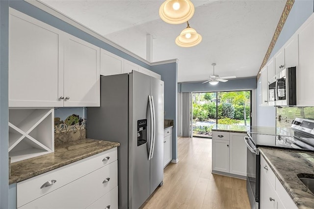 723 Timber Ridge Trl SW Unit B, Vero Beach, FL 32962 - kitchen with appliances with stainless steel finishes, dark stone counters, ceiling fan, and white cabinetry