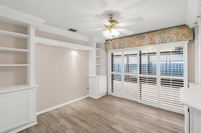 723 Timber Ridge Trl SW Unit B, Vero Beach, FL 32962 - unfurnished room with ceiling fan, light wood finished floors, built in shelves, and ornamental molding