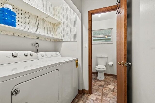 233 13th St SW, Vero Beach, FL 32962 - laundry area with washer and clothes dryer, baseboards, and stone finish floors