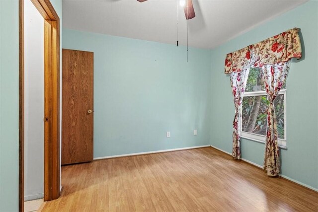 233 13th St SW, Vero Beach, FL 32962 - unfurnished room with wood finished floors, a ceiling fan, and baseboards