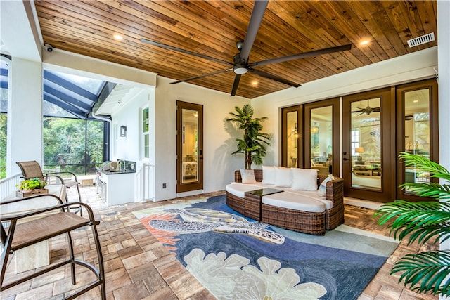 view of patio / terrace featuring glass enclosure, ceiling fan, and an outdoor hangout area