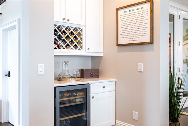 bar featuring white cabinets and beverage cooler