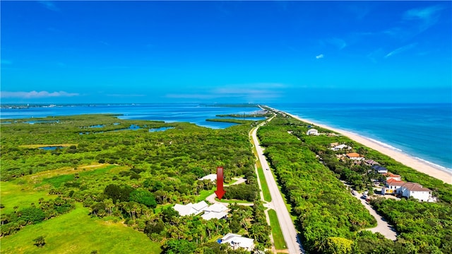 bird's eye view featuring a water view and a beach view