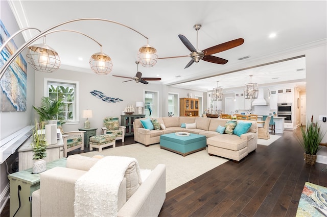 living room featuring hardwood / wood-style flooring, ceiling fan, and ornamental molding