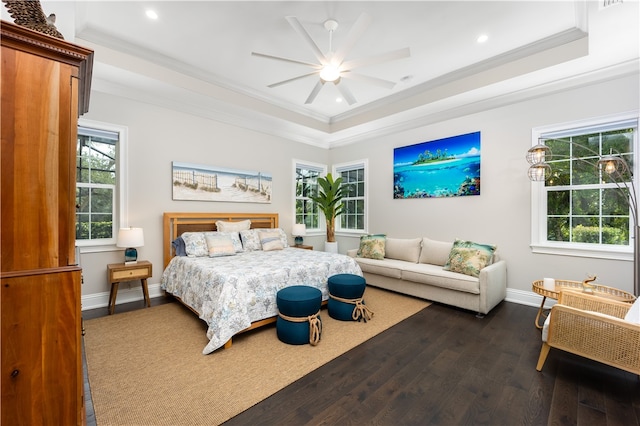 bedroom with dark hardwood / wood-style flooring, a raised ceiling, ceiling fan, and ornamental molding