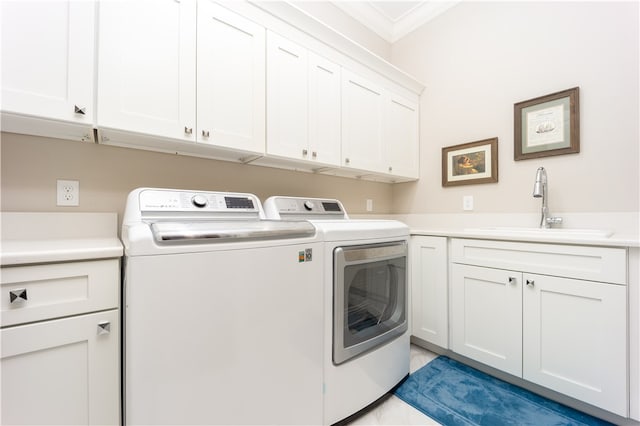 clothes washing area with cabinets, ornamental molding, sink, light tile patterned floors, and washing machine and clothes dryer