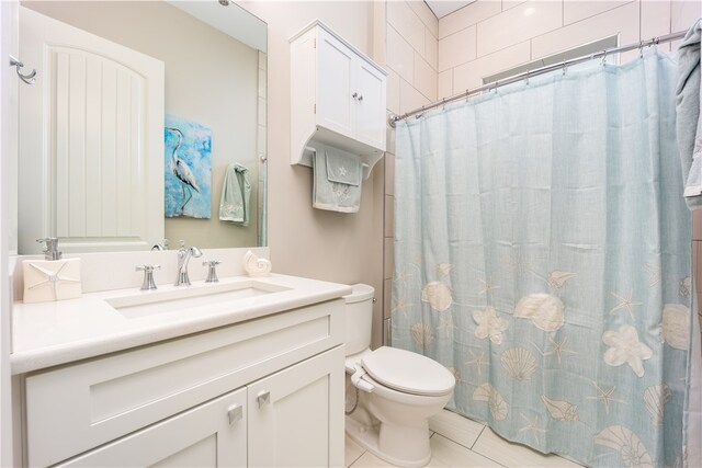 bathroom featuring tile patterned flooring, vanity, a shower with shower curtain, and toilet