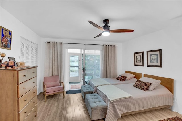 bedroom featuring light wood-style floors, access to outside, and a ceiling fan