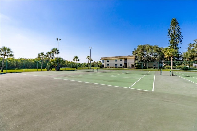 view of tennis court featuring fence