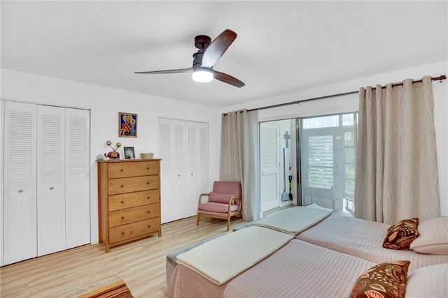 bedroom with multiple closets, ceiling fan, and light wood-style flooring