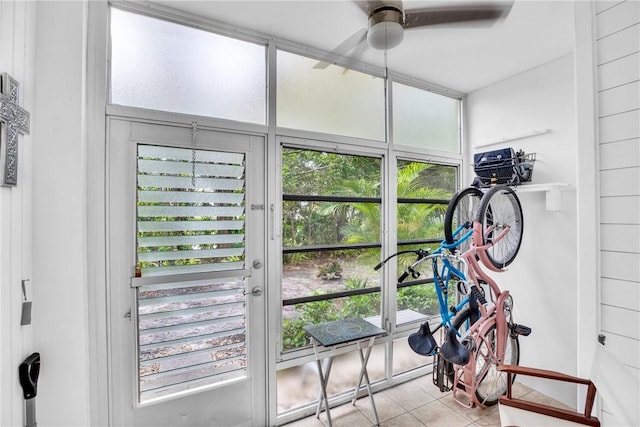 interior space with a ceiling fan and tile patterned floors