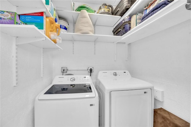 laundry room featuring washing machine and dryer and laundry area