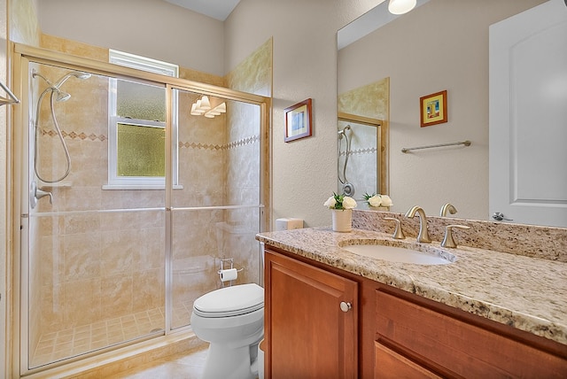 bathroom with toilet, vanity, tile patterned floors, and walk in shower