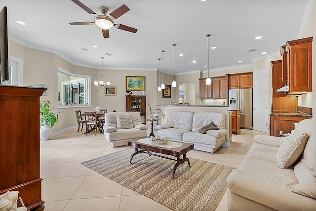 living room with ornamental molding, ceiling fan with notable chandelier, and light tile patterned floors