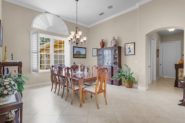 dining area with light tile patterned floors, an inviting chandelier, and crown molding