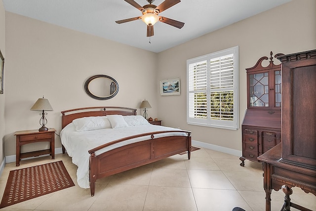 tiled bedroom featuring ceiling fan