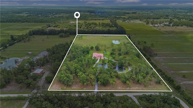 birds eye view of property with a water view and a rural view