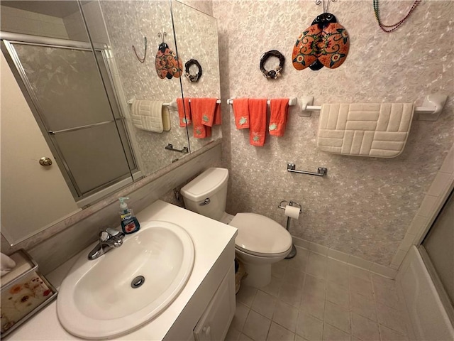 full bathroom featuring tile patterned flooring, vanity, toilet, and bath / shower combo with glass door