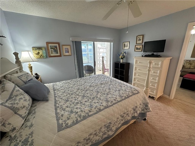 bedroom with a textured ceiling, light colored carpet, and ceiling fan