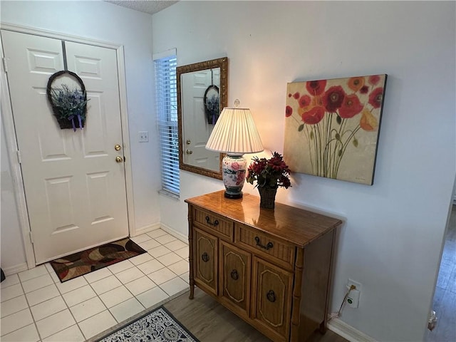 entryway with light tile patterned floors