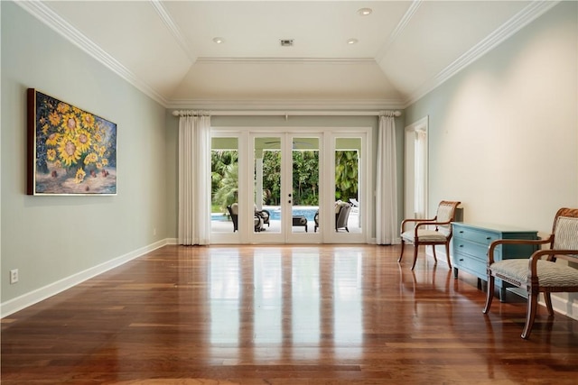 sitting room featuring lofted ceiling, dark hardwood / wood-style floors, ornamental molding, and french doors